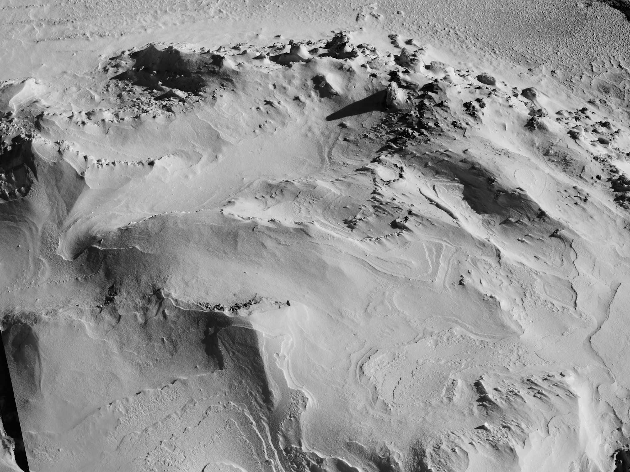 Ridged snow terrain photographed in low light
