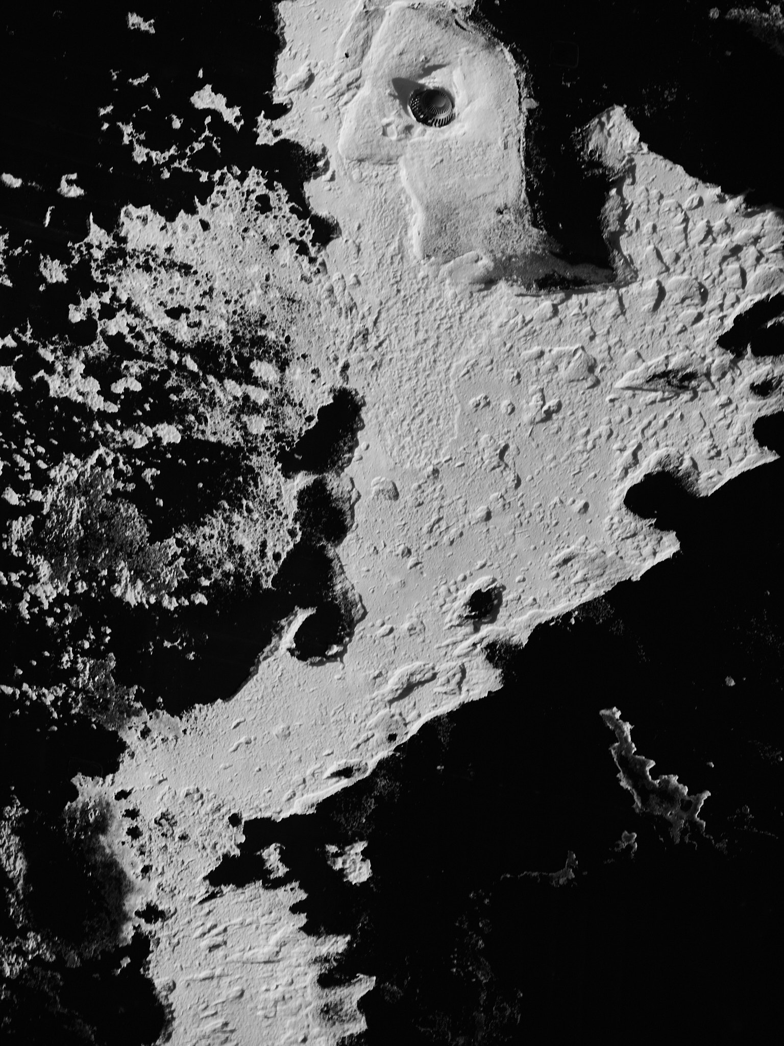 High-contrast snow and shadow resembling a lunar surface